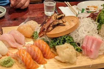 Large sushi and sashimi platter from Yechon Korean Restaurant in Annandale, featuring tuna, salmon, scallops, sea eel, and a hand roll.